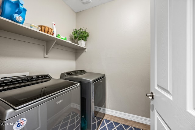 laundry area featuring dark hardwood / wood-style floors and washing machine and clothes dryer