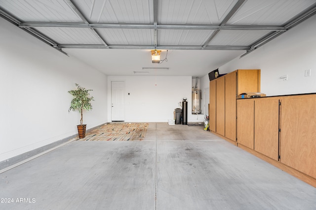 garage with a garage door opener and gas water heater