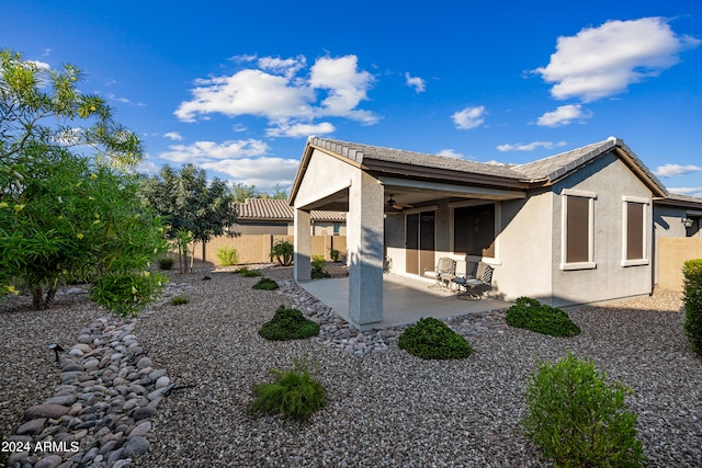 back of property with a patio