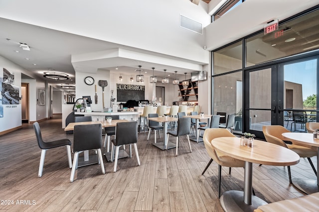 dining space featuring light hardwood / wood-style floors and french doors