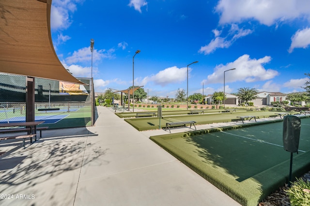 view of home's community with tennis court