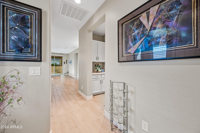 hall with light hardwood / wood-style flooring