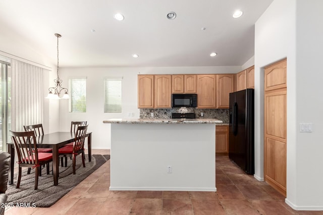 kitchen with an inviting chandelier, black appliances, decorative backsplash, decorative light fixtures, and light stone counters