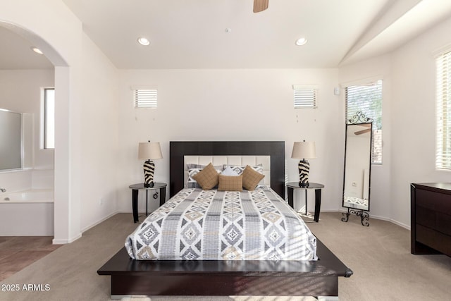 bedroom with ceiling fan, light carpet, and vaulted ceiling