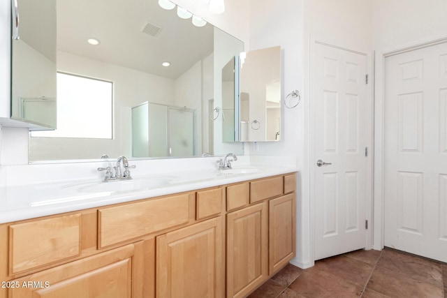 bathroom with tile patterned floors, vanity, and an enclosed shower