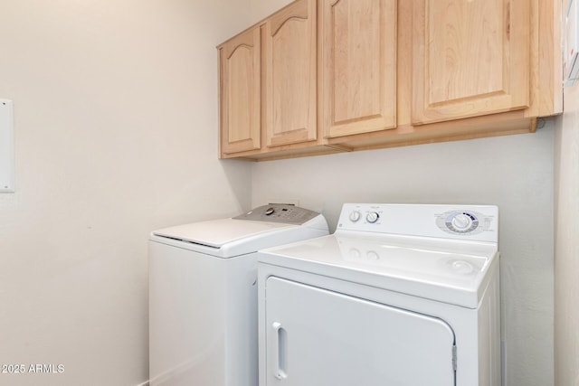 washroom with washer and clothes dryer and cabinets