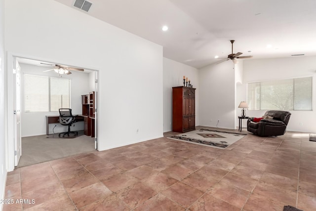 living room with ceiling fan and lofted ceiling