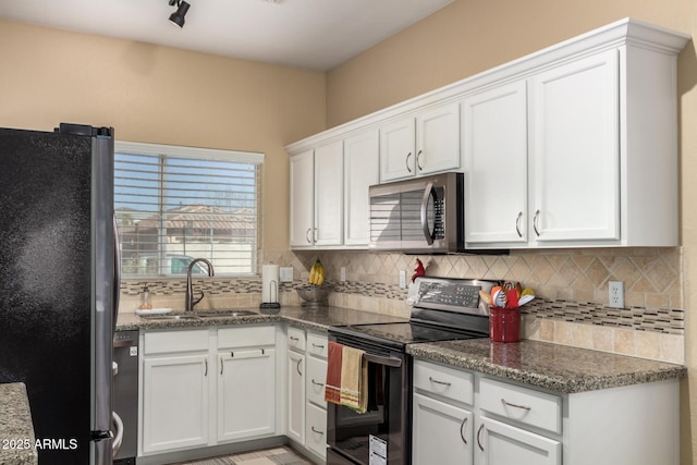 kitchen with white cabinets, backsplash, stainless steel appliances, and a sink