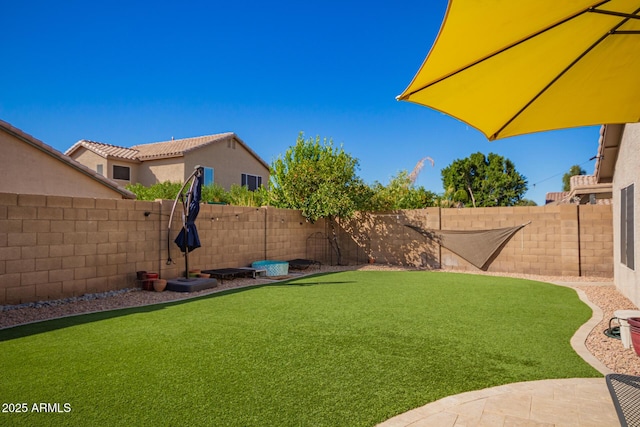 view of yard with a fenced backyard