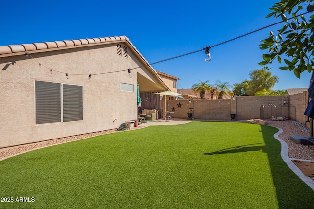 view of yard with a patio and a fenced backyard