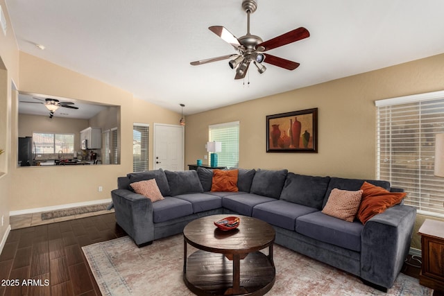 living room with lofted ceiling, dark wood-style floors, ceiling fan, and baseboards