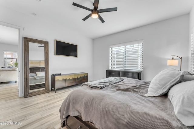 bedroom with light wood-type flooring and ceiling fan