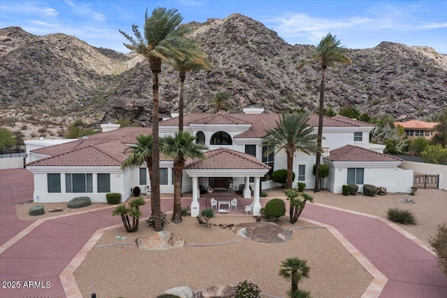 11809 S Montezuma Ct, Phoenix, AZ 85044 - mediterranean / spanish home featuring a mountain view, a patio, a tiled roof, and stucco siding