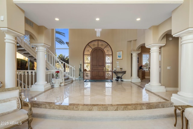 11809 S Montezuma Ct, Phoenix, AZ 85044 - entrance foyer featuring arched walkways, marble tiled floors, stairway, recessed lighting, and baseboards
