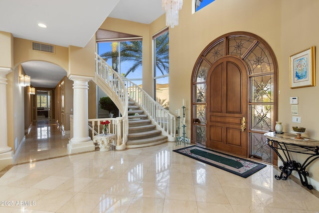 11809 S Montezuma Ct, Phoenix, AZ 85044 - foyer with arched walkways, a high ceiling, decorative columns, marble tiled floors, and recessed lighting