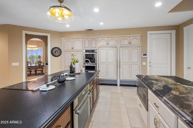 11809 S Montezuma Ct, Phoenix, AZ 85044 - kitchen featuring a chandelier, stainless steel appliances, recessed lighting, light tile patterned flooring, and arched walkways