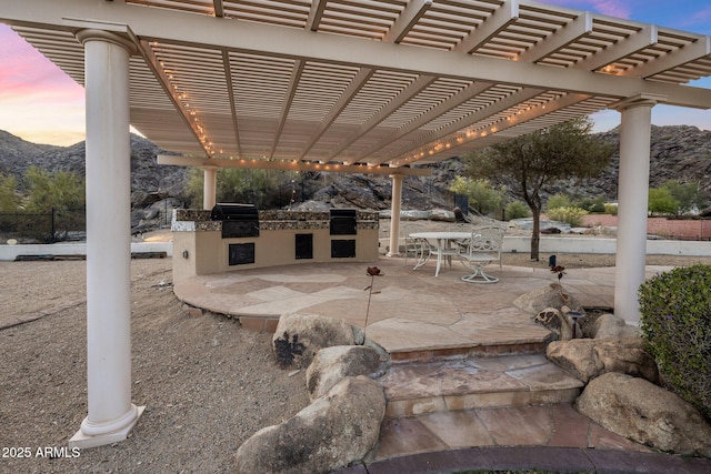 11809 S Montezuma Ct, Phoenix, AZ 85044 - view of patio featuring a grill, an outdoor kitchen, a pergola, and a mountain view