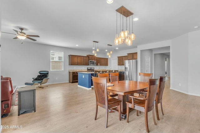 696 W Glen Canyon Dr, San Tan Valley, AZ 85140 - dining area with recessed lighting, ceiling fan with notable chandelier, baseboards, and light wood-style floors