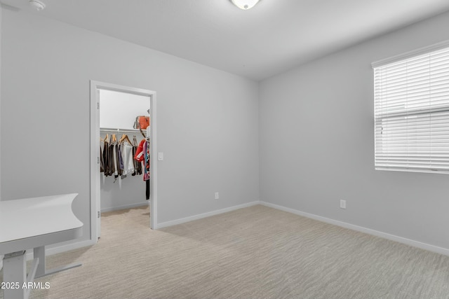 696 W Glen Canyon Dr, San Tan Valley, AZ 85140 - unfurnished bedroom featuring a walk in closet, light colored carpet, a closet, and baseboards