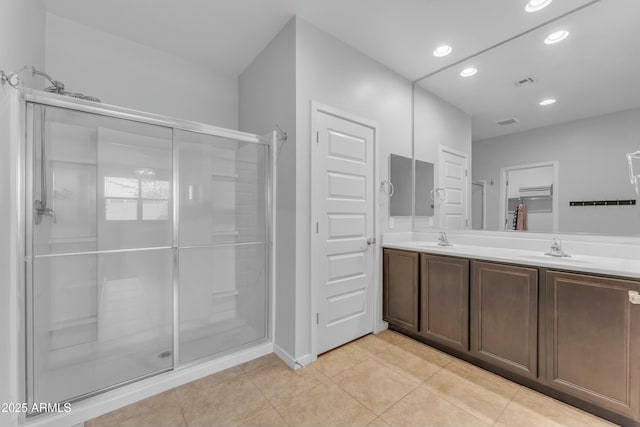 696 W Glen Canyon Dr, San Tan Valley, AZ 85140 - bathroom featuring visible vents, recessed lighting, a stall shower, a sink, and tile patterned flooring