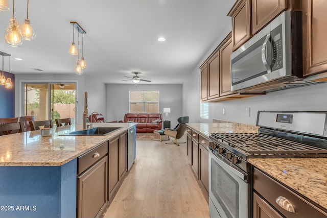 696 W Glen Canyon Dr, San Tan Valley, AZ 85140 - kitchen featuring light wood-style flooring, plenty of natural light, pendant lighting, and stainless steel appliances