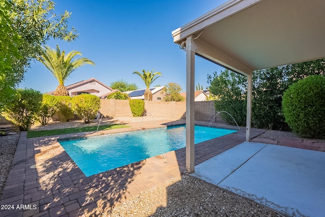 view of pool with pool water feature and a patio area