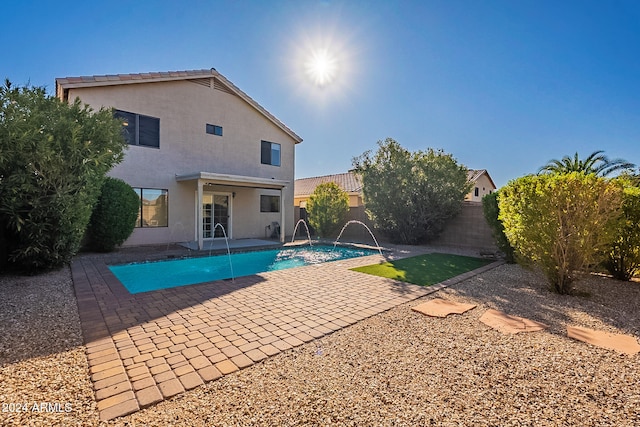 view of swimming pool with a patio and pool water feature