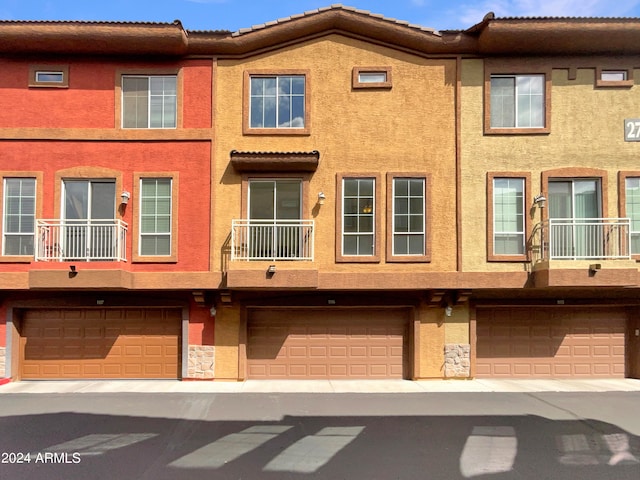 view of front of home featuring a balcony and a garage