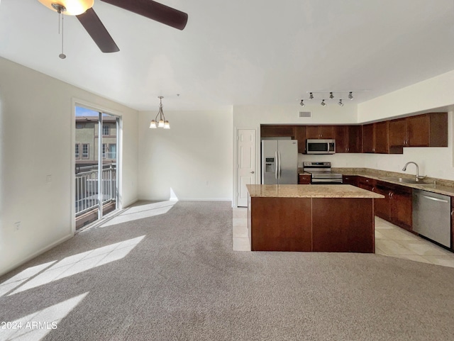 kitchen featuring appliances with stainless steel finishes, dark brown cabinetry, light carpet, track lighting, and ceiling fan with notable chandelier