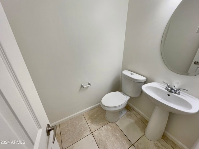 bathroom featuring toilet and tile floors