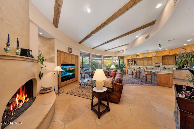 living room featuring sink and beamed ceiling