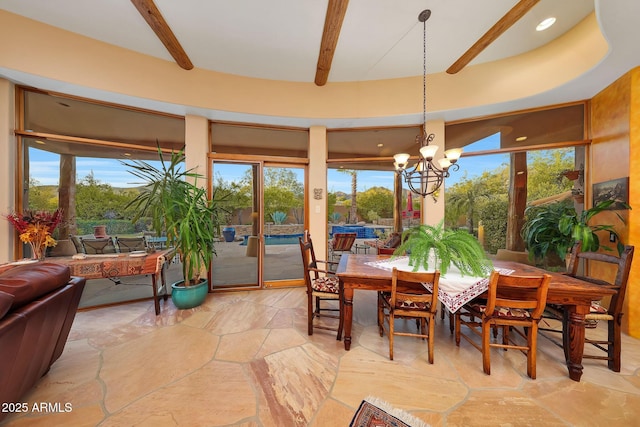 sunroom featuring beamed ceiling and a notable chandelier