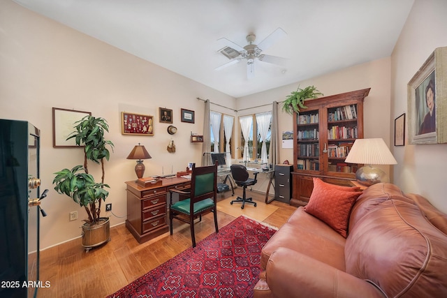 office space with ceiling fan and light hardwood / wood-style flooring