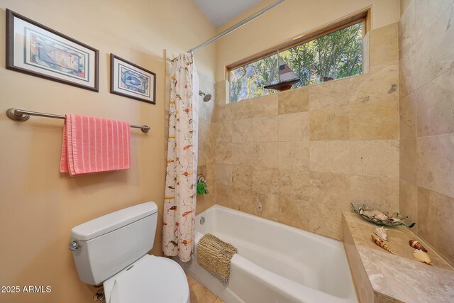 bathroom with toilet and shower / bathtub combination with curtain