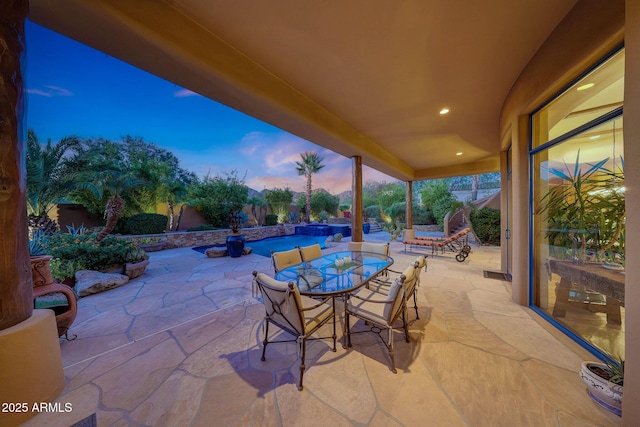 view of patio terrace at dusk