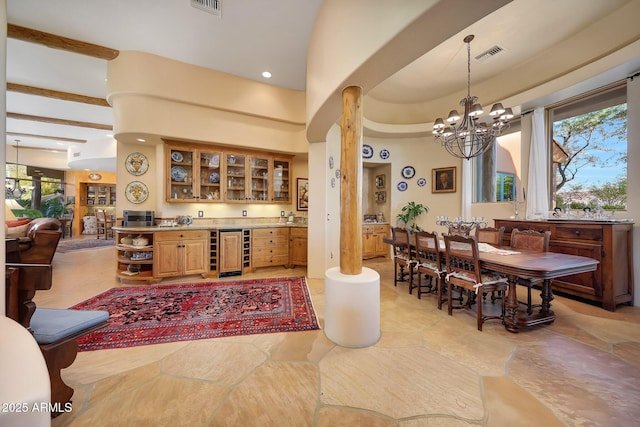 interior space featuring indoor bar, an inviting chandelier, and wine cooler