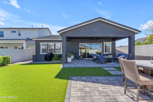 back of house with a gazebo, an outdoor living space, ceiling fan, a yard, and a patio