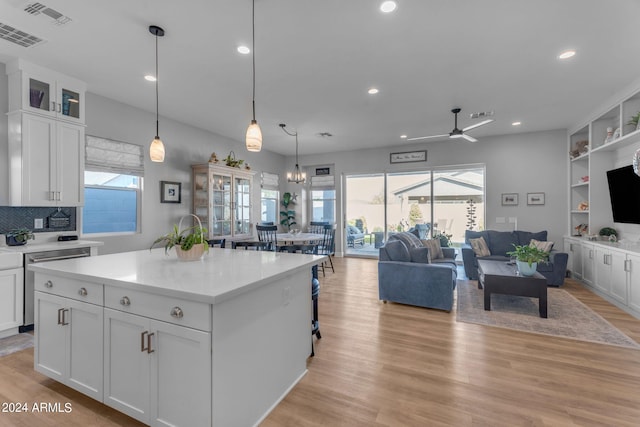 kitchen with white cabinetry, a healthy amount of sunlight, and a center island