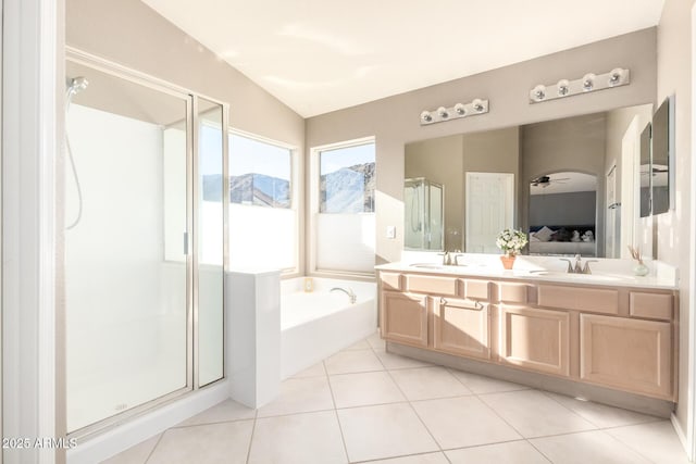 ensuite bathroom with a shower stall, tile patterned floors, a sink, and a garden tub