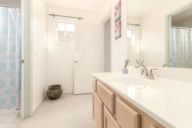 full bathroom featuring a shower with curtain, vanity, baseboards, and a wealth of natural light