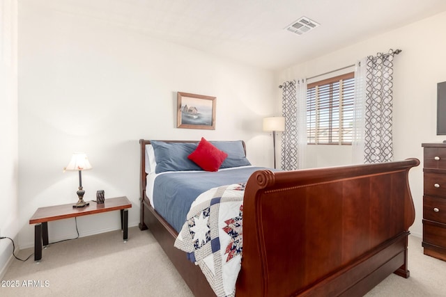 carpeted bedroom featuring baseboards and visible vents