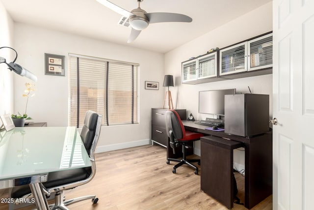 office space with baseboards, ceiling fan, and light wood-style floors