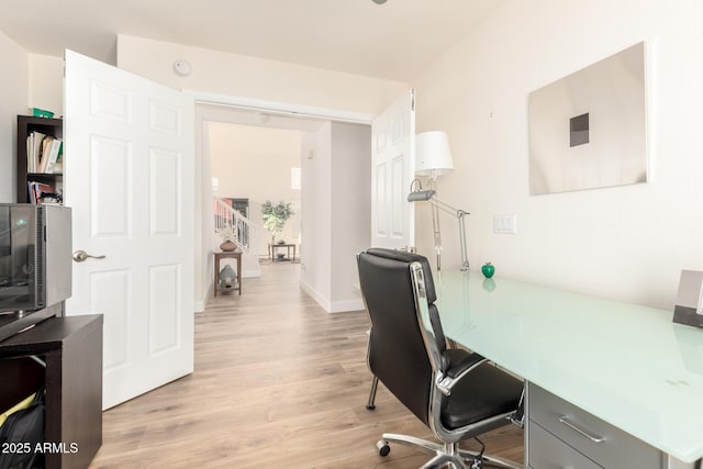 office with light wood-style flooring and baseboards