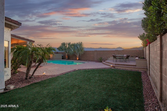 view of yard with a fenced backyard, a fenced in pool, and a patio