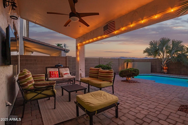 view of patio / terrace with a fenced in pool, a ceiling fan, outdoor lounge area, a fenced backyard, and visible vents