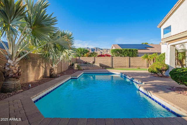 view of swimming pool with a patio, a fenced in pool, a fenced backyard, and a mountain view
