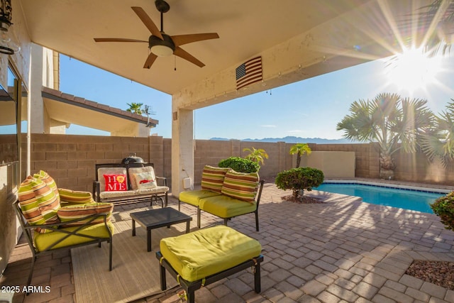 view of patio / terrace featuring a fenced backyard, a fenced in pool, an outdoor hangout area, and ceiling fan