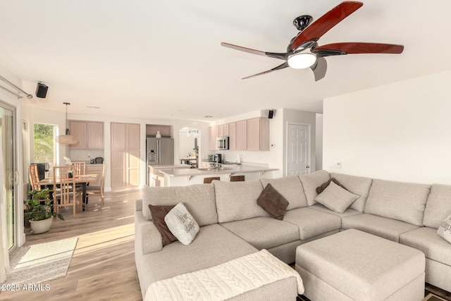 living area featuring ceiling fan and light wood-style floors