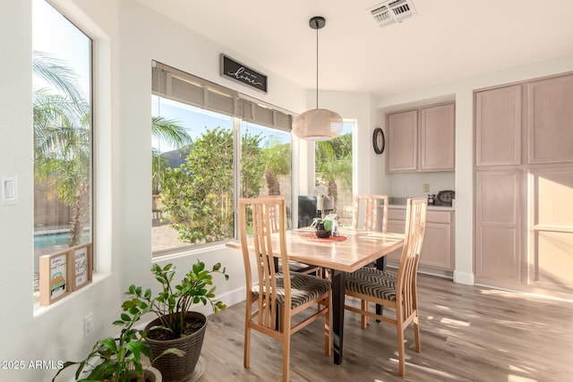 dining area featuring visible vents and light wood finished floors