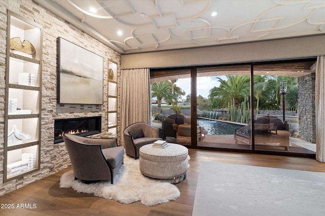 living area with wood-type flooring and a fireplace